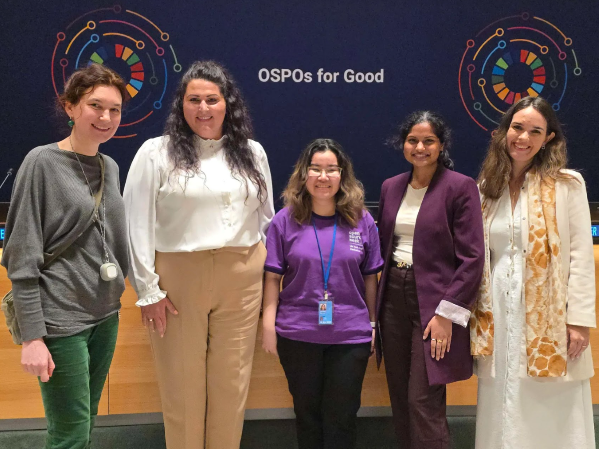 GW students standing in front of an OSPOs for Good sign at the UN Hackathon
