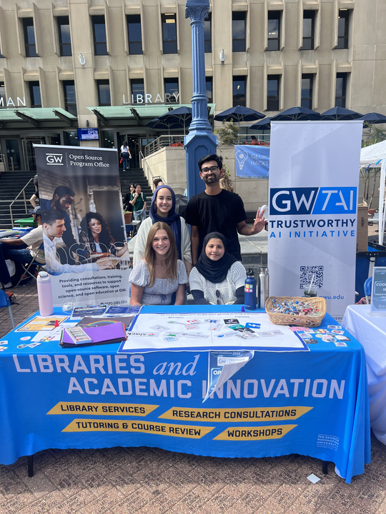 Student ambassadors sitting at the Open Source Program table 