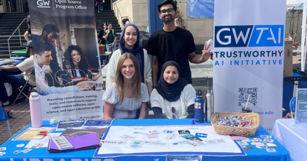 Student ambassadors sitting at the Open Source Program table 